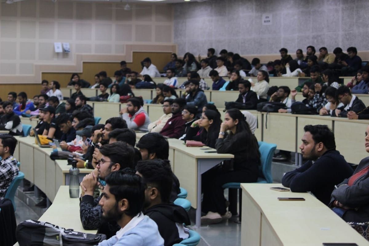 Students filling a university lecture hall during a session by Viren Gajjar